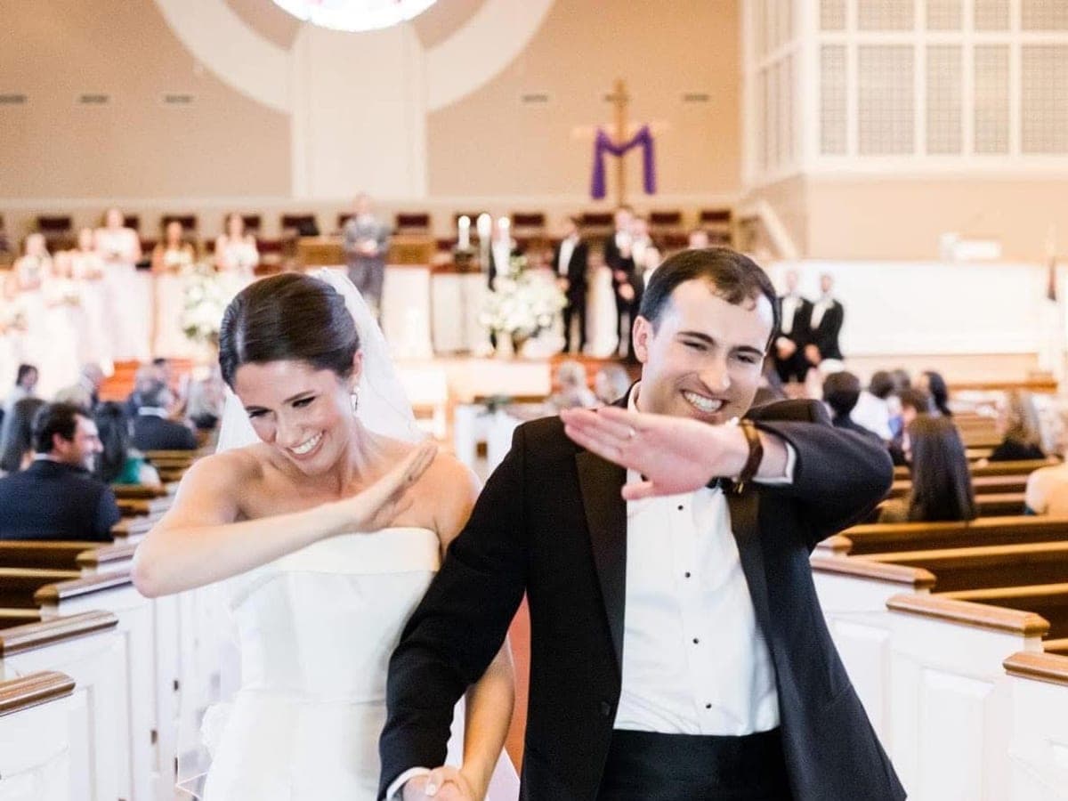 A couple dabbing during a wedding ceremony.
